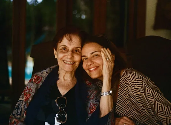 An adult daughter sharing a warm hug with her mother