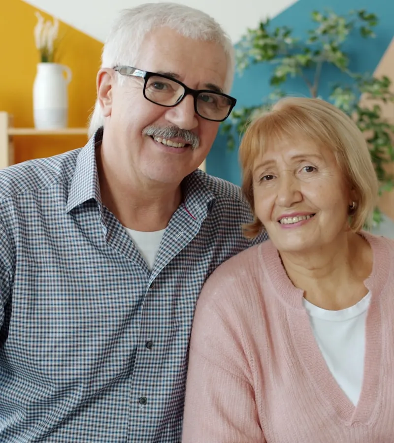 An older couple smiling together at home