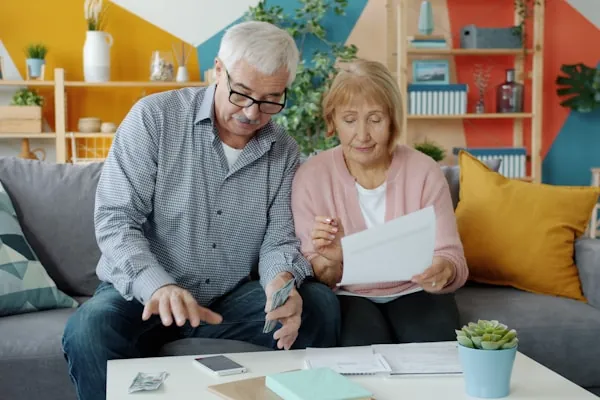 An older couple reviewing paperwork together at home